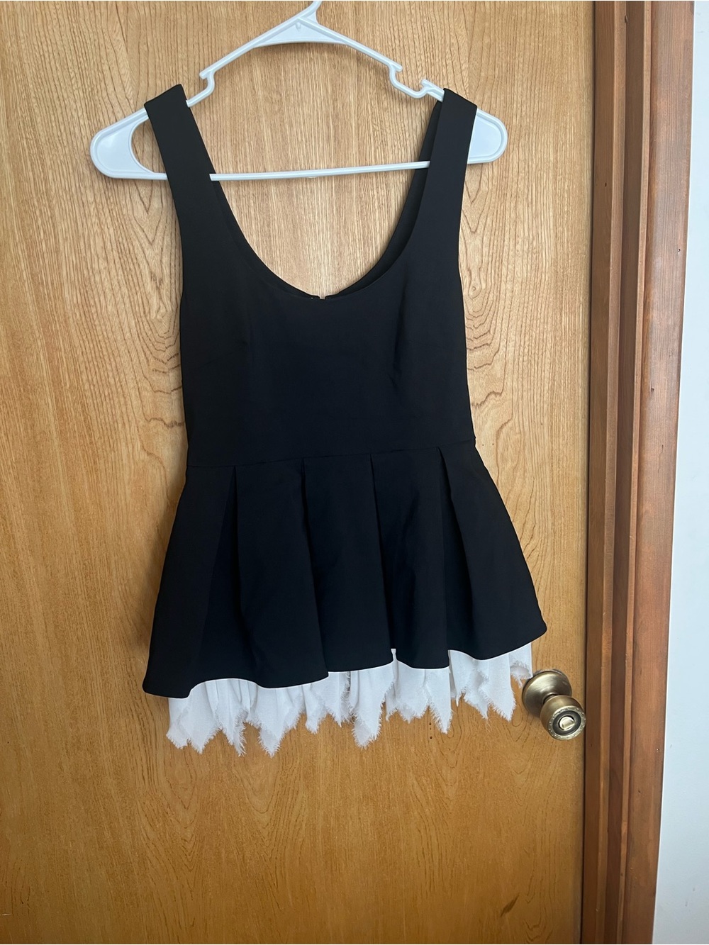 Black peplum tank top with white frilly trim